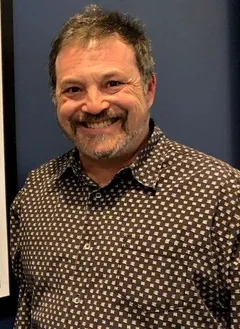 Jim Bernstein: Jim Bernstein next to a "Mighty Med" poster at the Walt Disney Company