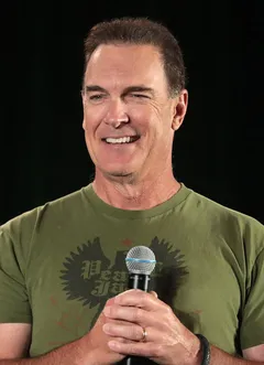 Patrick Warburton: Patrick Warburton speaking at the 2022 Phoenix Fan Fusion in Phoenix, Arizona.
